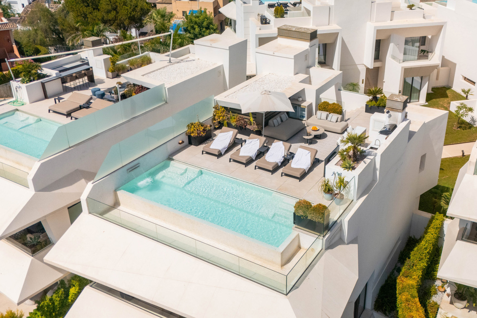 Luxury villa in Marbella Nueva Andalucía with indoor-outdoor pool design, blending modern architecture, greenery, and exclusive Costa del Sol living.