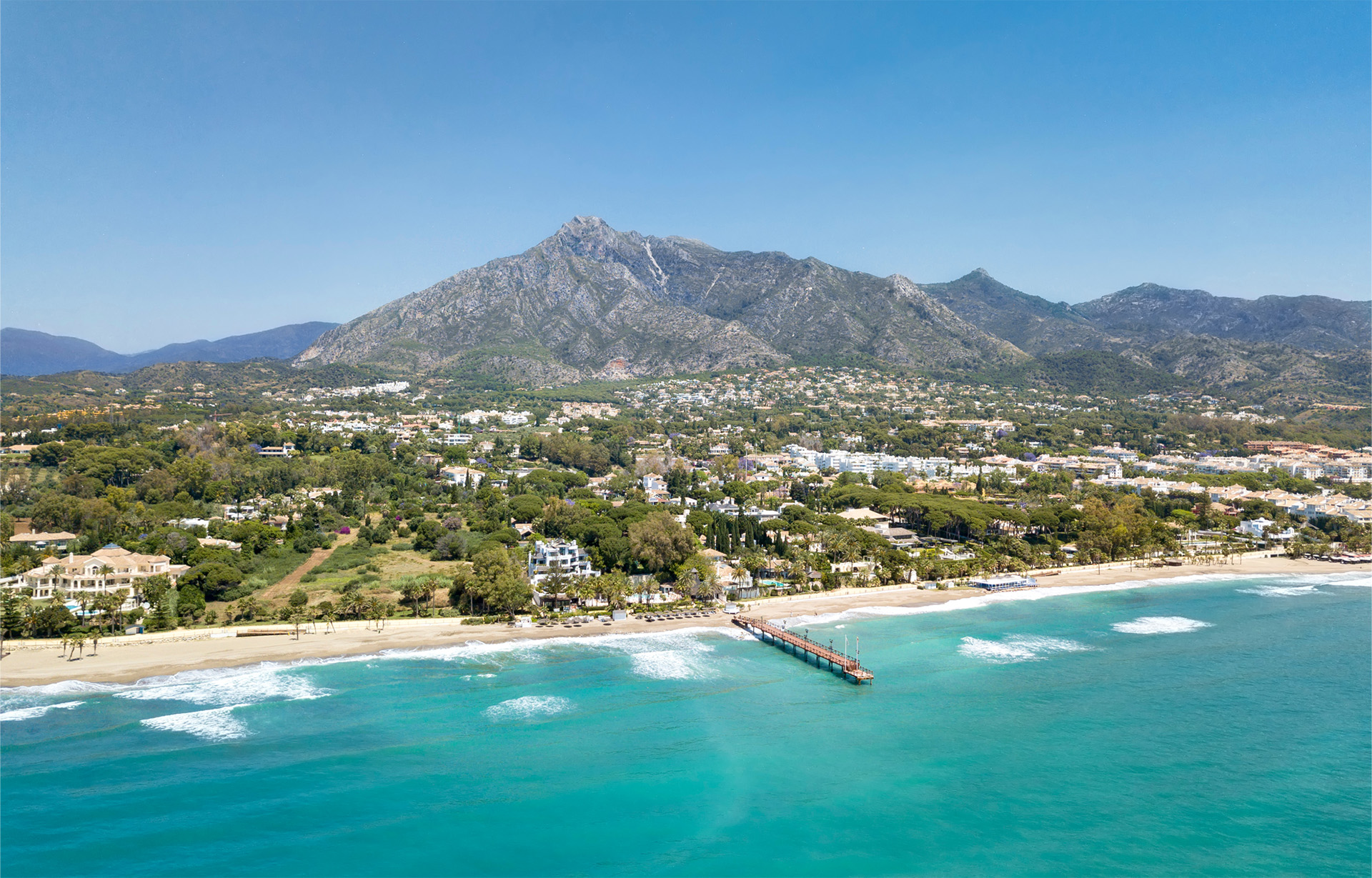 Aerial view of luxury villas and Mediterranean coastline on Marbella’s Golden Mile, showcasing exclusive lifestyle and prime real estate opportunities with Marbella Estates.