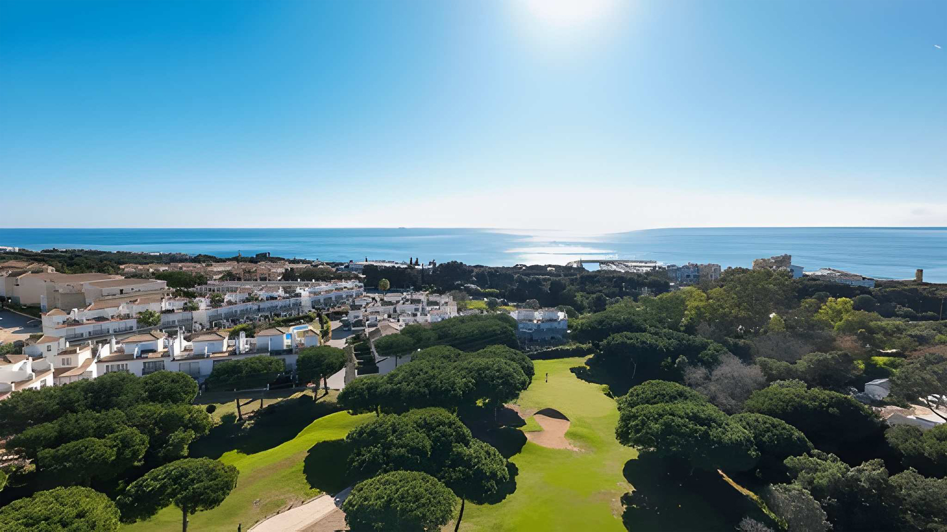 Aerial drone view of a luxury golf course in Marbella Costa del Sol surrounded by landscaped greenery illustrating the premium lifestyle and leisure amenities attractive to foreign property buyers.