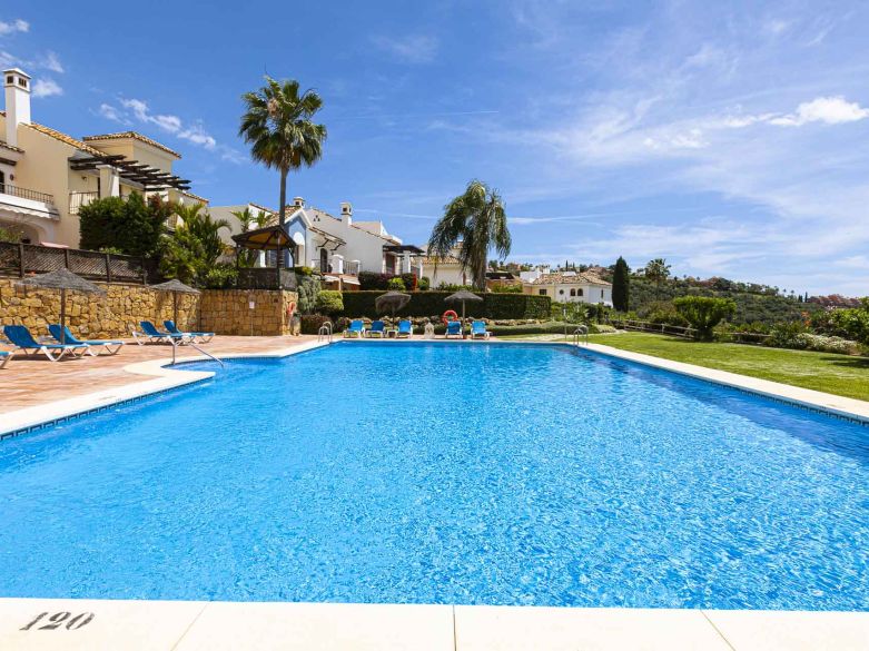 Beautiful south-facing, four bedroom townhouse in Los Almendros, part of the secure Los Arqueros Golf community in Benahavís